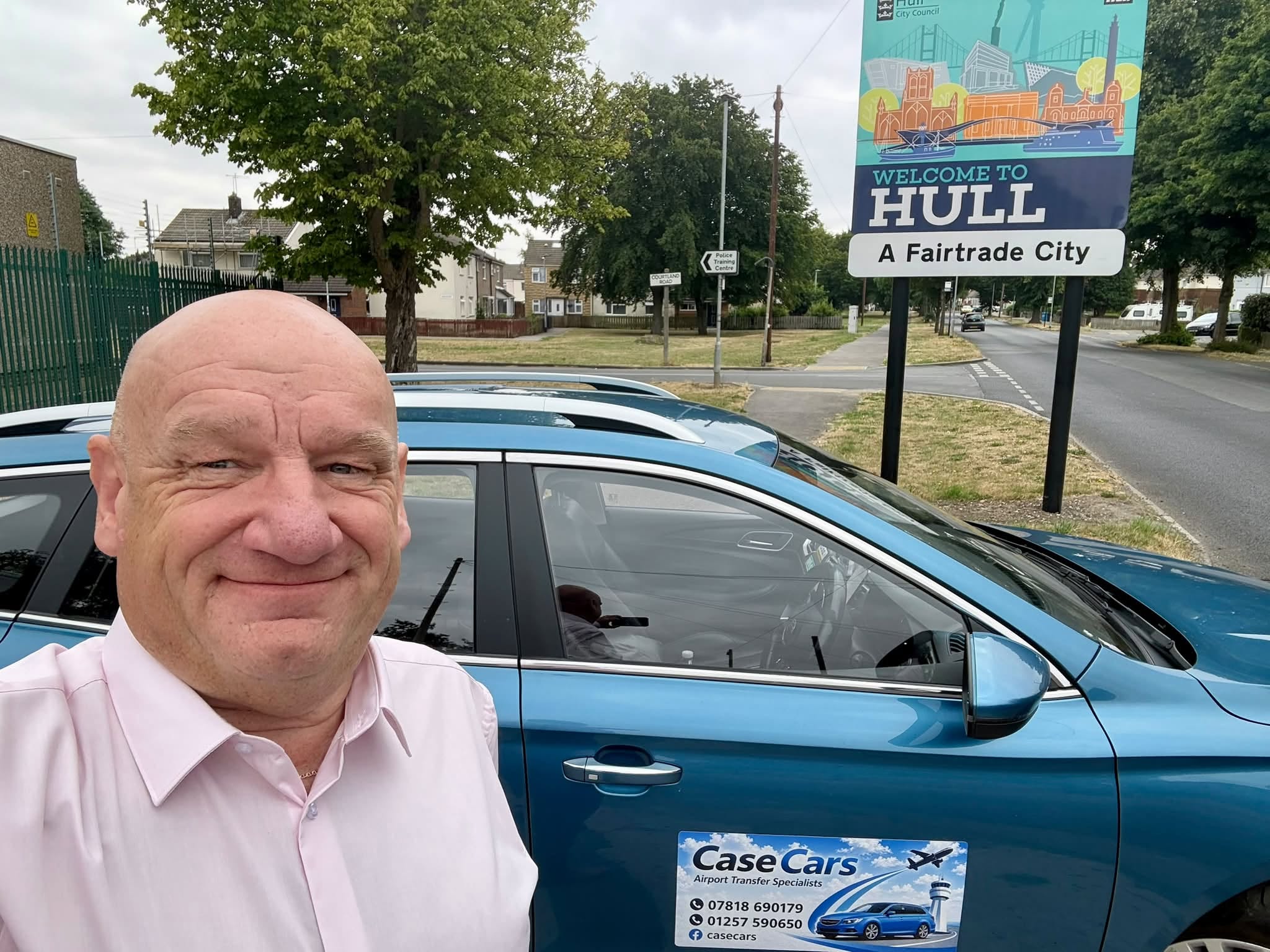 Nick Case standing beside the Case Cars airport transfer vehicle